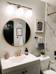 a bathroom with a sink, toilet and mirror