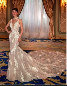 a woman standing in front of a window wearing a wedding dress