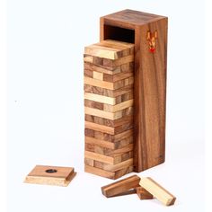 a wooden block tower next to two pieces of wood