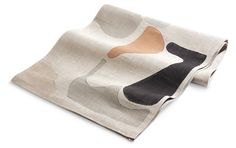 a white and black scarf with an abstract design on the front, sitting on a white surface