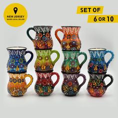 a set of six colorful glass vases sitting next to each other