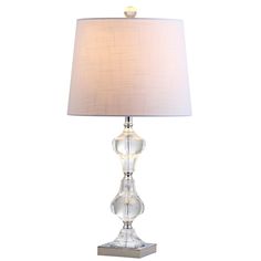 a clear glass table lamp with a white shade