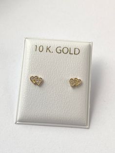 Solid yellow gold stud earrings, with a  gorgeous gold heart shape with cubic zirconia , perfectly designed for all ages but crafted with safety screw backs to protect the ears of children young girls and toddlers.  The 10K gold earring is perfect for babies, young girls and teenagers and beautiful enough for adults as well. Details: Metal: 10K Solid Gold Size: 3.8x5mm Back: screw back Condition: New Note: All parts are inspected before shipping, we are not responsible if you/or your baby lost the backings.  This Jewelry is meant to be adorned under adult supervision. Never leave young children unattended with our products. Please understand that the photos are ENLARGED to show detail for your benefit- please use the measurements provided in the item details/description to understand the s Gold Cubic Zirconia Heart Earrings In Dainty Style, Gold Heart Earrings With Cubic Zirconia, Gold Dainty Heart Earrings With Cubic Zirconia, Gold Double Heart Cubic Zirconia Earrings, Gold Cubic Zirconia Pierced Heart Earrings, Dainty Gold Heart Earrings With Cubic Zirconia, Gold Diamond Heart Earrings For Gift, Gold Double Heart Earrings For Anniversary, Gold Heart Earrings With Diamond Accents For Gift