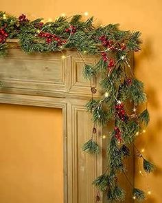 a fireplace decorated with christmas garland and lights