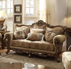 a living room filled with lots of furniture and pillows on top of a rug in front of a window