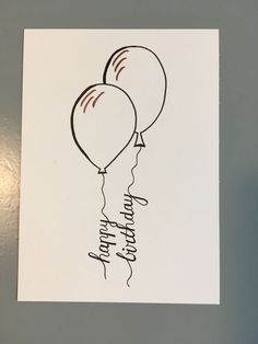 two balloons with the words happy birthday written on them are hanging from a white card