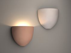 two light fixtures mounted on the wall next to each other