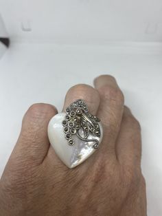 Vintage Mother of Pearl 925 Sterling Silver Marcasite Ring Mother of Pearl set in 925 Sterling Silver Marcasite ring I have size 6.25 Can be re sized for you, my jeweler would charge $10-$20 All rings are shipped in a nice gift box. Check out our over a THOUSAND great reviews Engraving is $4 per letter and is not always perfect depending on the piece. It can take a few days if the jeweler is busy. This is payable to Paypal Judithsltd@gmail.com White Sterling Silver Heart Ring, White Sterling Silver Heart Ring Fine Jewelry, Collectible White Gemstone Rings, Marcasite Ring, Sterling Silver Marcasite, Vintage Rainbow, Pearl Set, Ring Ring, Gmail Com