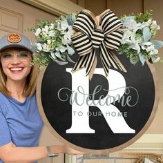 a woman standing next to a welcome sign