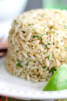 rice and lime on a white plate with chopsticks