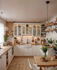 a kitchen with wooden floors and white cabinets