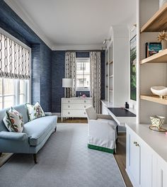 a living room filled with furniture and lots of shelves on the wall next to a window