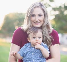 a woman holding a baby in her arms