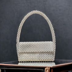 Introducing our exquisite Shimmering Metallic Bead Shoulder Bag, meticulously handcrafted to add a touch of elegance and sophistication to your ensemble. Crafted with  metallic silver beads, this bag exudes a radiant charm, perfect for both daytime outings and glamorous evening events. 🎈Our Handmade Silver Beaded Bag is designed with meticulous attention to detail, featuring intricate beadwork that showcases artisanal craftsmanship at its finest. The dazzling rhinestone accents further elevate Beaded Shoulder Bag, Bead Purse, Birthday Thanksgiving, Bag Silver, Beaded Bag, Beaded Purses, Beaded Bags, Sustainable Materials, Handmade Bags