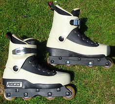 two roller skates sitting on the grass with their wheels still attached to each other