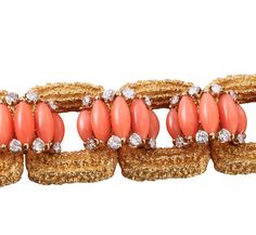 Exquisite 18k gold vintage 1960s bracelet, set with coral and approx. 3.00ctw VS-SI1/H diamonds. DESIGNER: Not Signed MATERIAL: 18k Gold GEMSTONES: Diamond, Coral DIMENSIONS: Bracelet is 6.75" long and 22mm wide. MARKED/TESTED: 18k, E65. WEIGHT: 86.2 grams CONDITION: Previously Owned/Excellent Condition Luxury Coral Jewelry For Formal Occasions, Luxury Coral Jewelry For Gifts, Elegant Red Bracelets For Evening, Luxury Coral Jewelry For Gift, Elegant Coral Bracelet For Gift, 1960s Bracelet, Sign Materials, Coral And Gold, Coral Jewelry