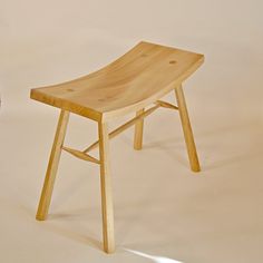 a wooden chair sitting on top of a white floor