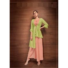 Introducing our new line of stylish contemporary Indian wear! This beautiful set is made from luxurious rayon fabric and features a combination of lime green and peach colors. It's adorned with subtle embroidery, and includes a crop top, palazzo pants, and an overcoat - making it truly unique. Perfect for any special occasion, this outfit will make you feel like a princess! #chirosbyjigyasa #indianclothingusa Fitted Pista Green Sharara For Spring, Fitted Green Sharara For Spring, Green Georgette Anarkali Set For Summer, Pista Green Anarkali Set For Spring, Summer Green Georgette Anarkali Set, Bollywood Style Pista Green Dress For Spring, Spring Pista Green Anarkali Set, Pista Green Bollywood Dress For Spring, Spring Long Sleeve Rayon Sets