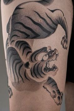 a man with a tiger tattoo on his thigh