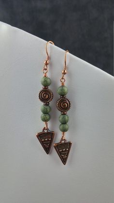 The green and copper of these earrings remind me of cactus at sunset in the Southwest. The glass beads are multi-colored and have small surface cracks that add wonderful depth to the earrings. They are about 2 3/4 inches (7 cm) long and are topped with copper ear wires. Southwestern Jewelry Kitchen, Colorful Beaded Copper Earrings Gift, Southwestern Brown Copper Jewelry, Bohemian Rust-colored Copper Jewelry, Wedding Bridesmaid Gifts, Rust-colored Copper Dangle Jewelry, Southwestern Style Red Nickel-free Earrings, Green And Copper, Southwestern Wedding