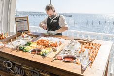 a man standing in front of a table filled with food