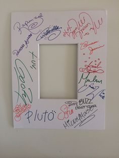 a white frame with many different colored writing on it