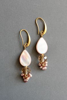 18k gold plated brass earrings with mother-of-pearl, glass, and freshwater pearls. Each earring weighs .12oz and measures 2.5in from top of hook. Dangle Mother Of Pearl Drop Earrings, Dangle Pearl Drop Earrings In Mother Of Pearl, Pearl Drop Earrings In Mother Of Pearl, Pearl Charm Drop Earrings In Mother Of Pearl, Pearl Drop Mother Of Pearl Dangle Earrings, Luxury Mother Of Pearl Drop Earrings, Gold Pearl Drop Earrings In Mother Of Pearl, Pearl White Mother Of Pearl Drop Earrings, Gold Pearl Drop Cluster Earrings