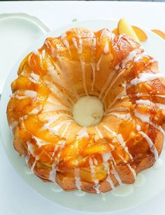 a bundt cake sitting on top of a white plate next to an apple slice