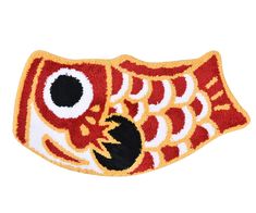 a red and yellow fish with black eyes on it's back side, embroidered onto a white background