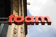 a red foam sign hanging from the side of a building