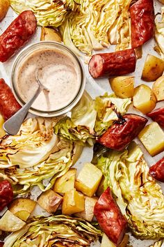 some food that is laying out on a table with a spoon in it and sauce