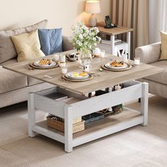 a coffee table with breakfast plates on it in front of a couch and two chairs