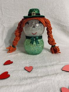 "Handcrafted glass lighted Girl Leprechaun.  Made out of glass bubble vases.  LED fairy lights will illuminate the body of the character.  Lights have 8 different modes, brightness adjustment. and timer.  The battery pack is accessible from behind the character to allow battery replacement.  Remote for lights and batteries are included.  Approx 9\" x 4\"." Girl Leprechaun, Fishbowl Craft, Bubble Vases, Dollar Tree Diy Home Decor, Dollar Tree Easter Crafts, Light Girls, Glass Bubble, Diy Home Decor Ideas, Led Fairy Lights