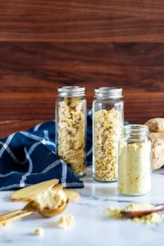 three jars filled with different types of food