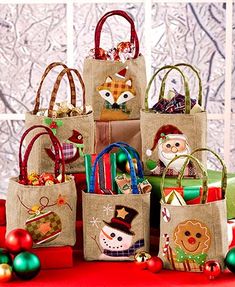 several bags are stacked on top of each other in front of christmas decorations and ornaments