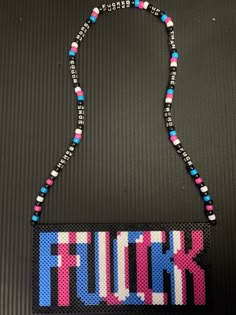 a beaded necklace with the word flunk on it