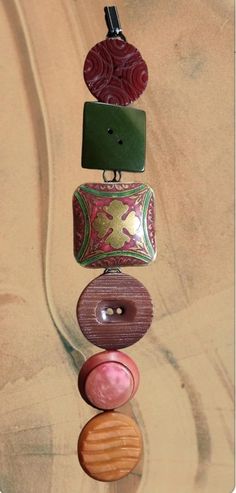 an assortment of different types of buttons hanging from a string