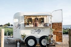 the food truck is parked on the side of the road with its door open to let people inside