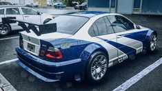 a blue and white car parked in a parking lot