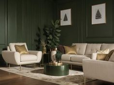 a living room with green walls and white couches, gold pillows on the coffee table