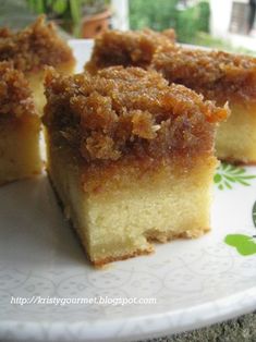 several pieces of cake on a plate with green leaves and flowers in the back ground