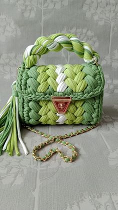 a green and white purse sitting on top of a table