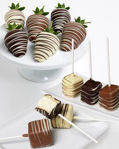 several chocolate covered strawberries on a white plate