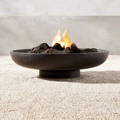 a fire pit sitting on top of a cement floor