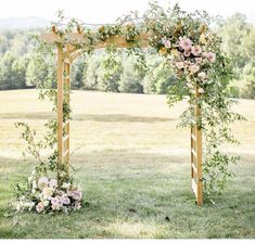 an outdoor wedding ceremony setup with flowers and greenery