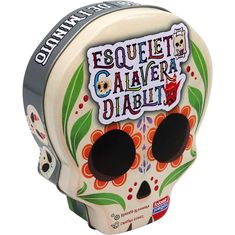 a white and black sugar skull with flowers on it's head, says esquelet caavera diabili