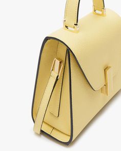 Valextra Iside Mini Solid in Vaniglia Envelope flap top with turn-lock closure Rolled top handle Detachable shoulder strap Interior card slot Gold hardware Leather outer Signature hand-painted, black lacquered Costa edges 7.7”W x 5.5” H x 3.7”D Made in Italy Modern Yellow Shoulder Bag For Formal Occasions, Elegant Yellow Satchel For Formal Occasions, Luxury Yellow Satchel For Evening, Luxury Yellow Satchel For Formal Occasions, Yellow Luxury Satchel For Formal Occasions, Chic Yellow Flap Bag For Evening, Luxury Yellow Formal Satchel, Chic Yellow Evening Flap Bag, Elegant Yellow Satchel