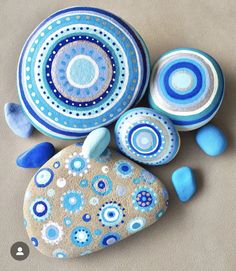 blue and white painted rocks sitting next to each other