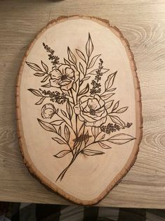 a piece of wood with some flowers on it