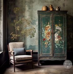 an armoire with flowers painted on it next to a chair